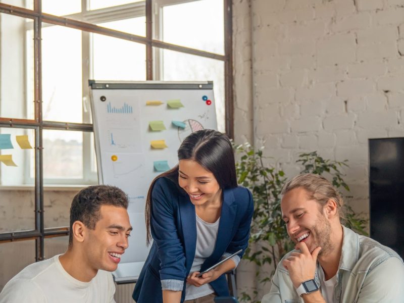 vertical-shot-of-multiracial-business-people-with-laptop-and-smartphone-having-meeting-in-office-.jpg